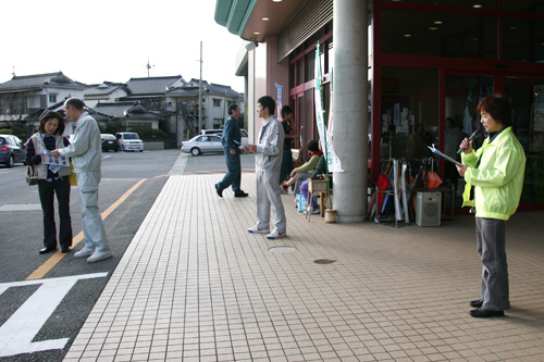 お店の前でアナウンスをしながら、チラシを配り啓発