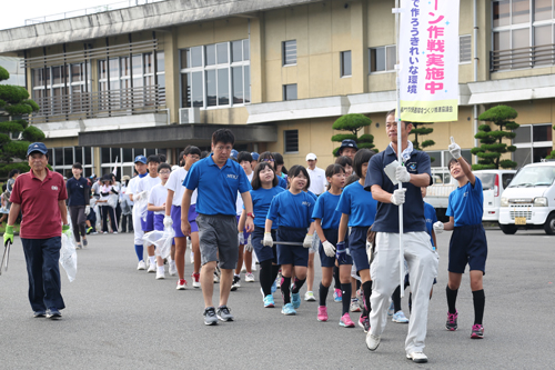 ごみ袋を手に、日置農村環境改善センターを出発する参加者