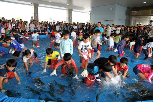 魚のつかみ取りは大人気で朝早くから行列ができた