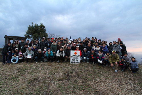 登山参加者で記念写真。この日は約130人が参加した