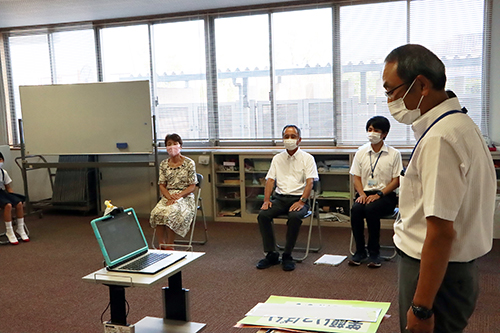 会議室でパソコンのカメラに向かって話す大塚校長