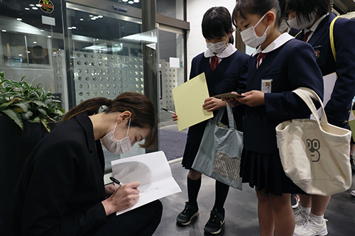例会後にスポーツ少年団の選手のみんなにサインする奥村選手